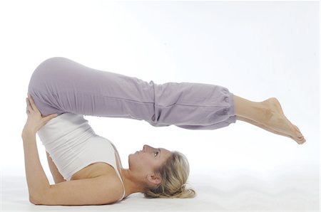 sweaty tank top - Woman doing gymnastics Stock Photo - Premium Royalty-Free, Code: 689-03733467