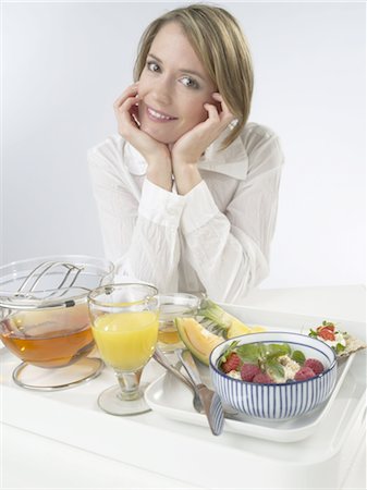 Woman sitting at breakfast table Stock Photo - Premium Royalty-Free, Code: 689-03733632