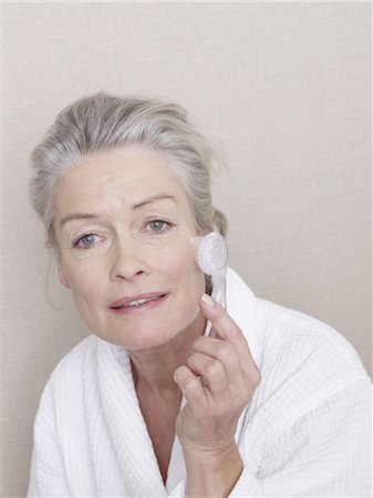 Senior woman massaging her cheek Stock Photo - Premium Royalty-Free, Code: 689-03733679