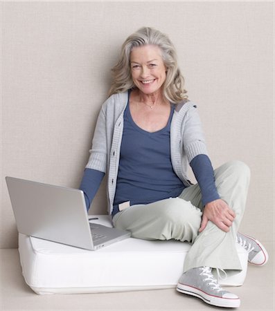 sitting on cushion - Senior woman using laptop Stock Photo - Premium Royalty-Free, Code: 689-03733673