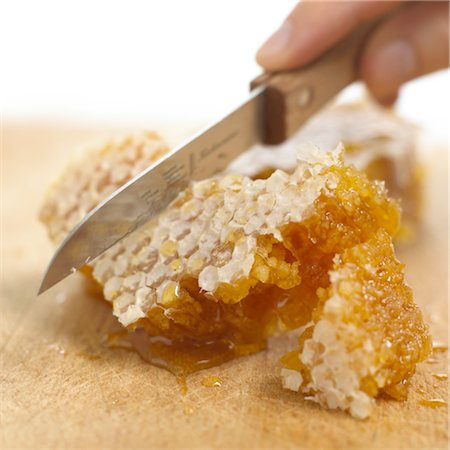 picture of person with honey - Knife cutting honeycomb Stock Photo - Premium Royalty-Free, Code: 689-03733692