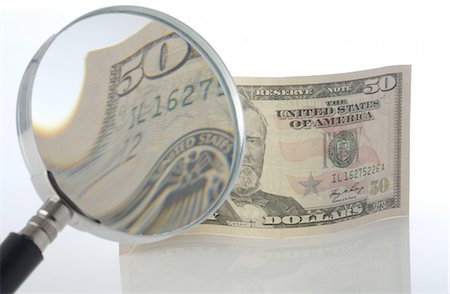 finance analysis - Dollar note under magnifying glass Stock Photo - Premium Royalty-Free, Code: 689-03733740