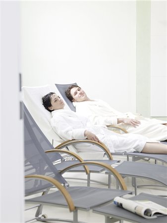 relaxing woman robe spa - Man and woman lying in deckchairs Stock Photo - Premium Royalty-Free, Code: 689-03733766