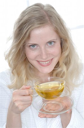 pretty 30 year old women with blond hair - Woman holding glass of tea Stock Photo - Premium Royalty-Free, Code: 689-03733805