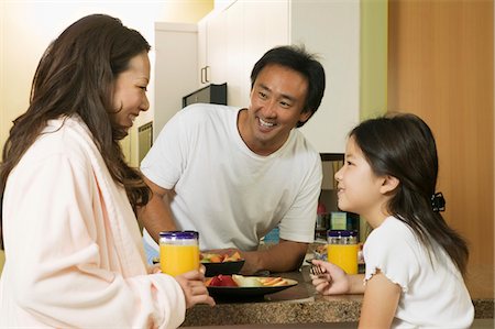 Family Enjoying Breakfast in kitchen Stock Photo - Premium Royalty-Free, Code: 694-03318053