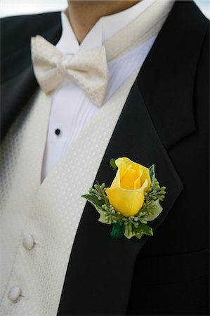 Yellow rose on Grooms tuxedo, (close-up) Stock Photo - Premium Royalty-Free, Code: 694-03318351