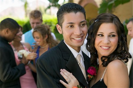 simsearch:694-03318741,k - Well-dressed teenage couple embracing outside school dance Fotografie stock - Premium Royalty-Free, Codice: 694-03318758