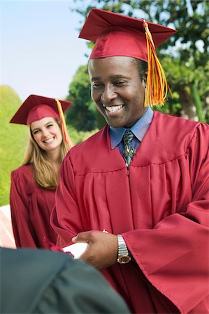 simsearch:693-06014222,k - Graduate shaking hand of dean outside Stock Photo - Premium Royalty-Free, Code: 694-03318819