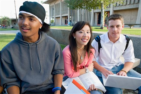 ethnically diverse college student studying with laptops or computers - Three friends outside school Stock Photo - Premium Royalty-Free, Code: 694-03319634