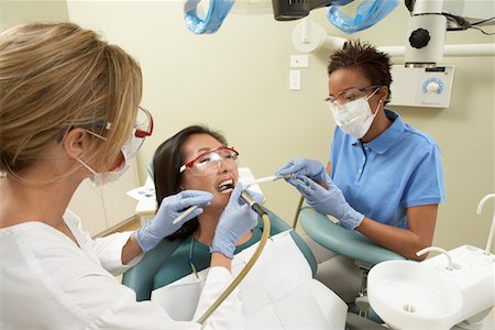 dental drill fear - Two dentists examining female patient in surgery Stock Photo - Premium Royalty-Free, Code: 694-03319843