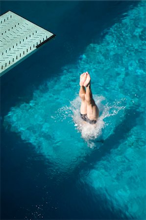 Swimmer diving into swimming pool Stock Photo - Premium Royalty-Free, Code: 694-03319984