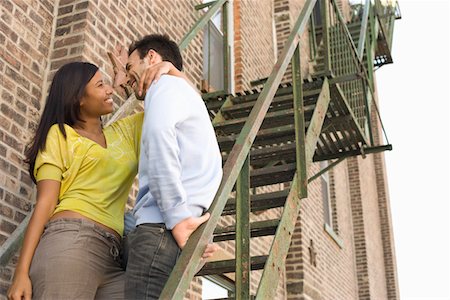 residence couple - Young Couple on Fire Escape Stock Photo - Premium Royalty-Free, Code: 694-03325353