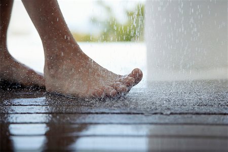 feet walking indoors - Woman standing under outdoor shower, close up of feet, low section, Stock Photo - Premium Royalty-Free, Code: 694-03326324