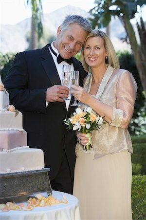 senior couple holding wedding photo - Middle-aged couple toasting near wedding cake, portrait Stock Photo - Premium Royalty-Free, Code: 694-03326844