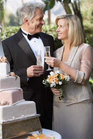 senior couple holding wedding photo - Middle-aged couple toasting near wedding cake, portrait Stock Photo - Premium Royalty-Free, Code: 694-03326843