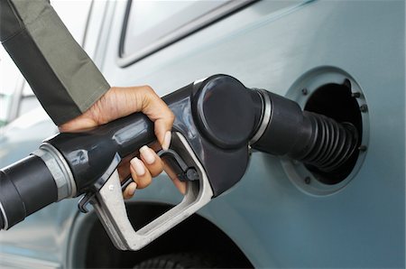 filling station - Woman pumping gas, close up of hand Stock Photo - Premium Royalty-Free, Code: 694-03326903