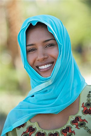 portraits one person muslim - Portrait of muslim woman in blue headscarf, smiling Stock Photo - Premium Royalty-Free, Code: 694-03327076