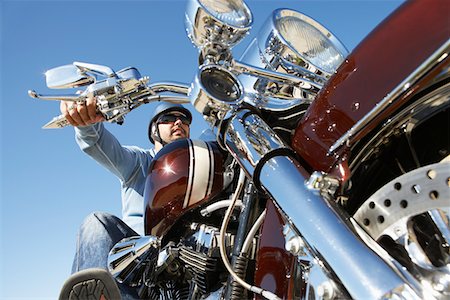 Biker riding motorcycle, low angle view Stock Photo - Premium Royalty-Free, Code: 694-03327401