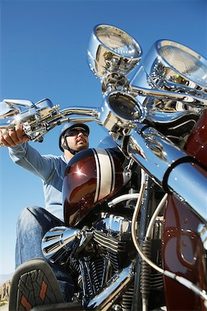 Biker riding motorcycle, low angle view Stock Photo - Premium Royalty-Free, Code: 694-03327402