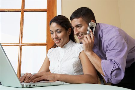 Business man and woman working with laptop at desk in office Stock Photo - Premium Royalty-Free, Code: 694-03327633