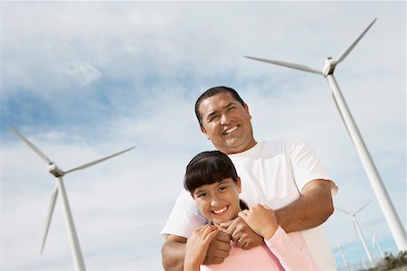 simsearch:694-03328242,k - Father embracing daughter (7-9) at wind farm, portrait Stock Photo - Premium Royalty-Free, Code: 694-03328194