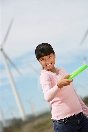 people flying disc - Girl (7-9) throwing disc at wind farm, portrait Stock Photo - Premium Royalty-Free, Code: 694-03328201