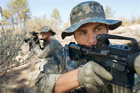 Two soldiers with weapons, close-up Fotografie stock - Premium Royalty-Free, Codice: 694-03328366