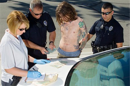 Police Officer Arresting Young Man Stock Photo - Premium Royalty-Free, Code: 694-03328404