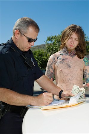 Officer Making a Drug Bust Stock Photo - Premium Royalty-Free, Code: 694-03328408