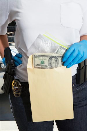 Police Officer Putting Money in Evidence Envelope Stock Photo - Premium Royalty-Free, Code: 694-03328473