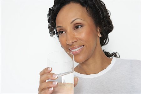 Woman drinking glass of water, studio shot Stock Photo - Premium Royalty-Free, Code: 694-03329073