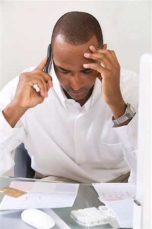 phone with pain - Anxious Man Doing Finances Stock Photo - Premium Royalty-Free, Code: 694-03329218