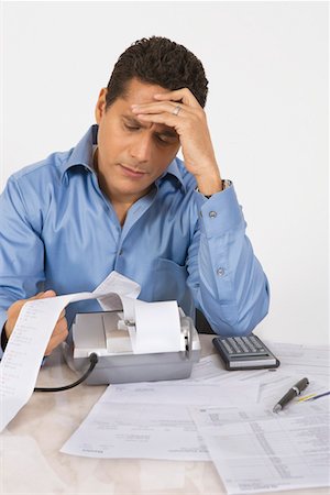 Man Calculating Finances Stock Photo - Premium Royalty-Free, Code: 694-03329230