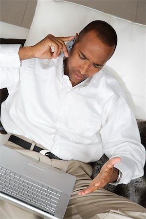 simsearch:694-03329214,k - Businessman Using Laptop and Talking on Cell Phone Foto de stock - Royalty Free Premium, Número: 694-03329259