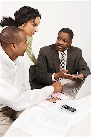 Couple Talking with Accountant Stock Photo - Premium Royalty-Free, Code: 694-03329378