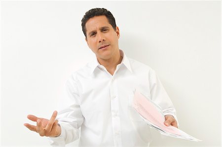 Frustrated Man with Documents Foto de stock - Sin royalties Premium, Código: 694-03329455