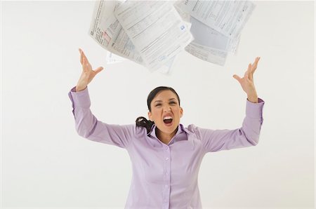 frustrated bill - Woman Tossing Forms in the Air Stock Photo - Premium Royalty-Free, Code: 694-03329464