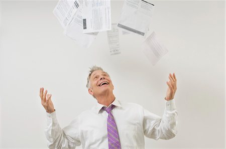 debt - Man Throwing Bills in the Air Stock Photo - Premium Royalty-Free, Code: 694-03329467