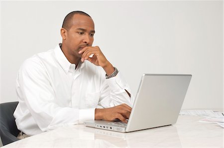 despair african american - Man Using a Laptop Stock Photo - Premium Royalty-Free, Code: 694-03329484