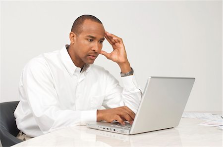 Man Using a Laptop Stock Photo - Premium Royalty-Free, Code: 694-03329485