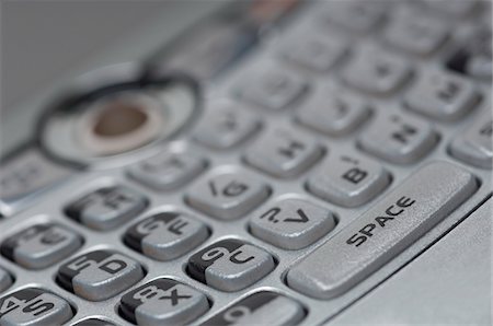 silver letter - Keypad of PDA, close-up Stock Photo - Premium Royalty-Free, Code: 694-03329842