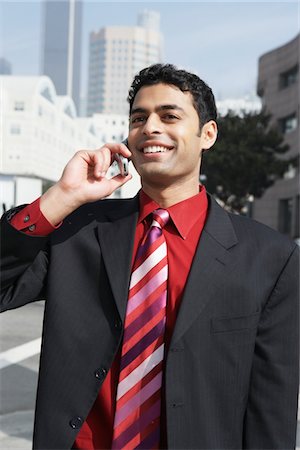 Business man using mobile phone on city street Stock Photo - Premium Royalty-Free, Code: 694-03320065