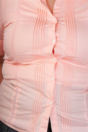 Overweight Woman in tight blouse, mid section, front view Stock Photo - Premium Royalty-Free, Code: 694-03321224