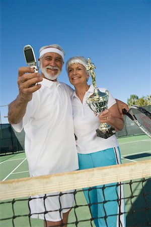 simsearch:693-06016661,k - Tennis players holding award cup and photographing Stock Photo - Premium Royalty-Free, Code: 694-03321649