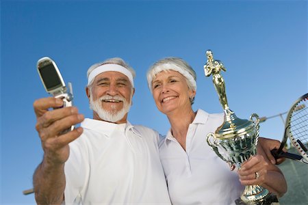 simsearch:693-06016661,k - Tennis players holding award cup and photographing Stock Photo - Premium Royalty-Free, Code: 694-03321651