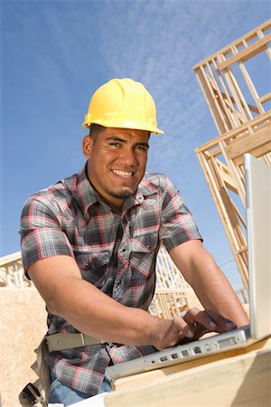 Construction worker using laptop Stock Photo - Premium Royalty-Free, Code: 694-03321974