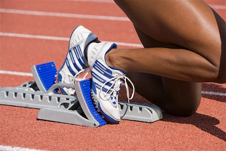 starting block kneeling race track - Female athlete in starting block, ready to run Stock Photo - Premium Royalty-Free, Code: 694-03323068