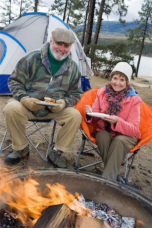 Senior couple eating by tent Stock Photo - Premium Royalty-Free, Code: 694-03323805