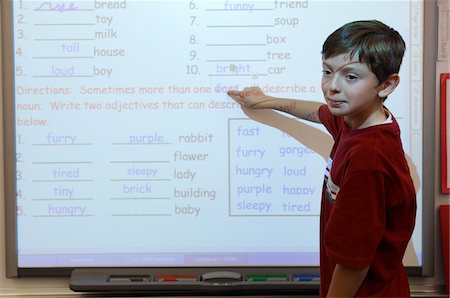 Student in Classroom Doing Math Foto de stock - Sin royalties Premium, Código: 694-03330035