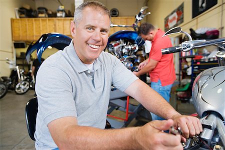 Mechanic Working on Motorcycle Stock Photo - Premium Royalty-Free, Code: 694-03330255